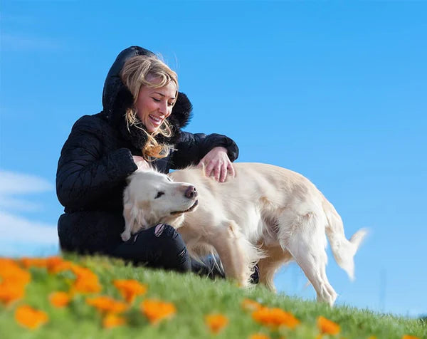Pet parent outdoors with her senior golden retriever